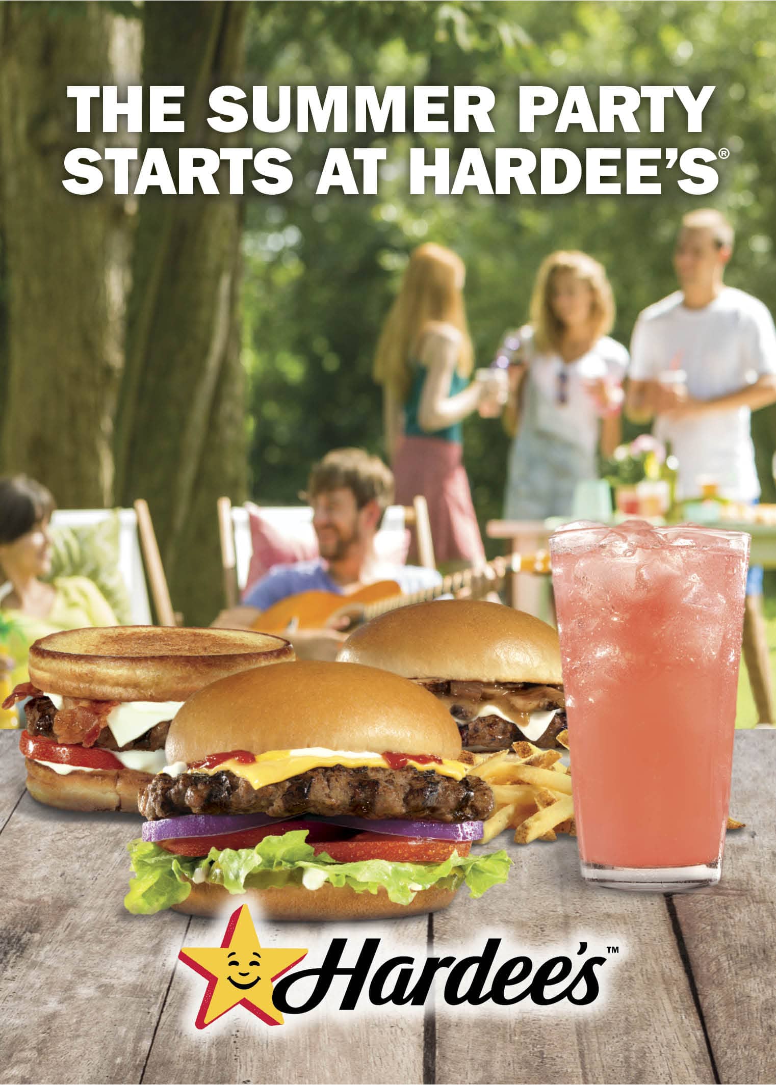 hamburgers on a picnic table with pink lemonade